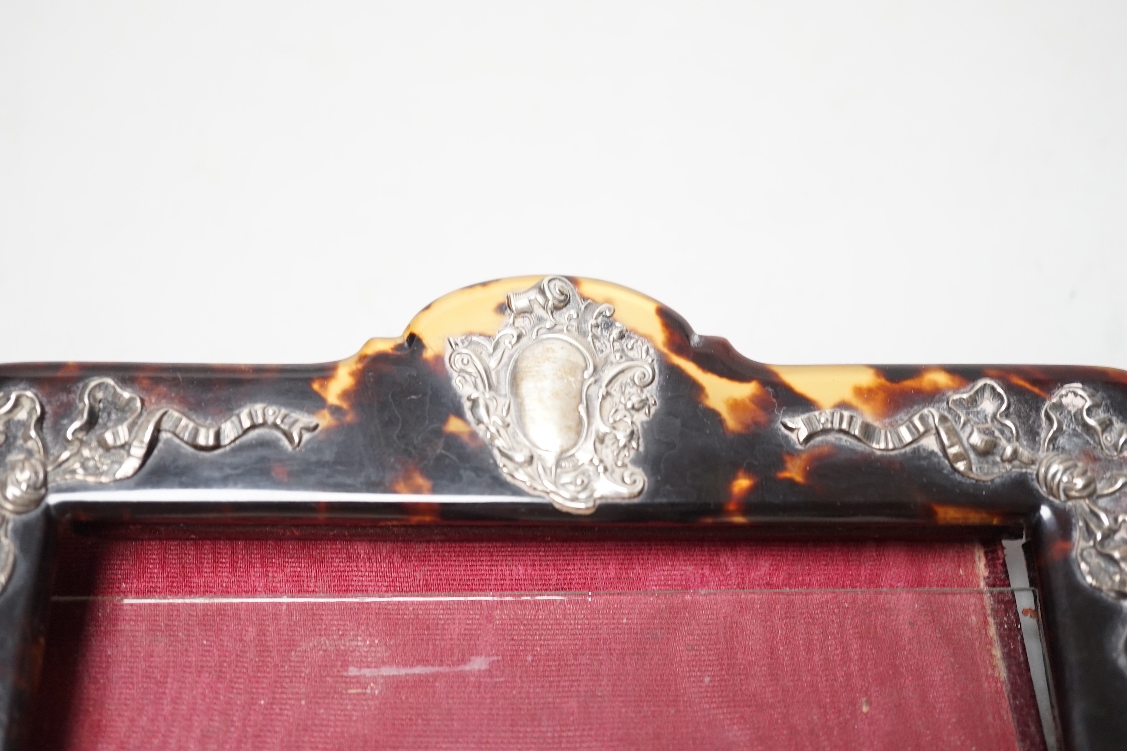 An Edwardian silver mounted tortoiseshell photograph frame, import marks for London, 1909, width 15.9cm (a.f.).